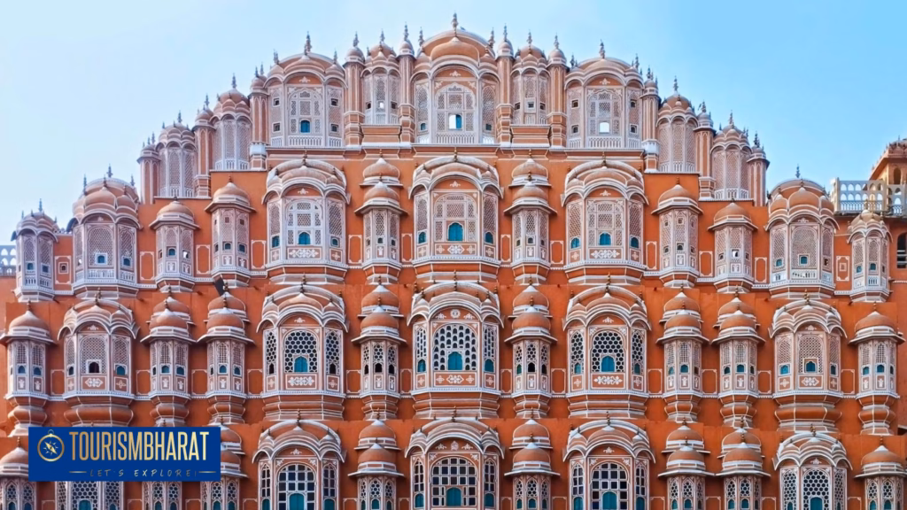 Hawa Mahal honeycomb sandstone facade lit gold at sunset from Badi Choupad street level